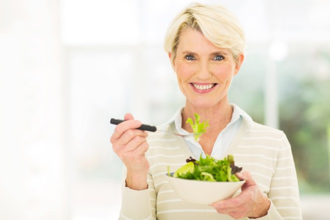 beautiful senior female vegetarian eating salad